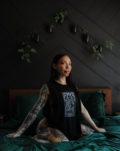 Model wearing the Hanged Man Tarot Tank by The Pretty Cult, black cotton tarot graphic tank top