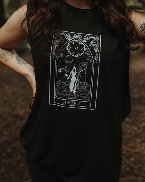 Close-up of Justice Tank graphic printed on black cotton fabric