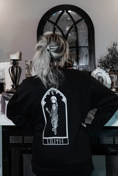 Model wearing the Lilith Sweatshirt, black graphic crewneck with front and back print