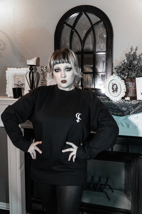 Model wearing the Lilith Sweatshirt, black graphic crewneck with front and back print